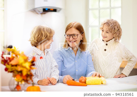 Family cooking Thanksgiving dinner 94318561