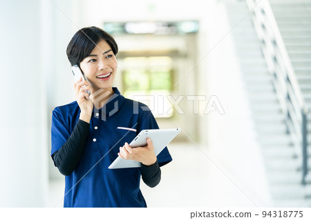 Caregiver operating a tablet 94318775