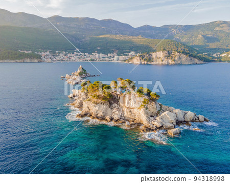 Sveta Nedelja is an islet on the Adriatic Sea, in Montenegrin municipality of Budva. It is located opposite the town of Petrovac na Moru in Montenegro. It has a small church on it Portrait of a Sveta Nedelja is an islet on the Adriatic Sea, in Montenegrin municipality of Budva. It is located opposite the town of Petrovac na Moru in Montenegro. It has a small church on it Portrait of a 94318998