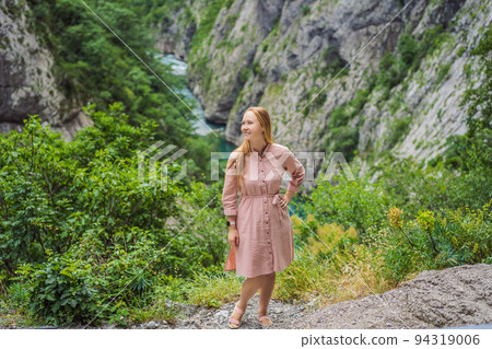 Woman tourist on background of purest waters of the turquoise color of the river Moraca flowing among the canyons. Travel around Montenegro concept Portrait of a disgruntled girl sitting at a cafe Woman tourist on background of purest waters of the turquoise color of the river Moraca flowing among the canyons. Travel around Montenegro concept Portrait of a disgruntled girl sitting at a cafe 94319006