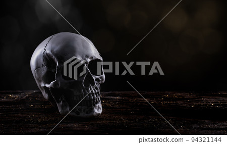 Halloween human skull on an old wooden table over black background. Shape of skull bone for Death head on halloween festival which show horror evil tooth fear and scary with fog smoke, copy space Halloween human skull on an old wooden table over black background. Shape of skull bone for Death head on halloween festival which show horror evil tooth fear and scary with fog smoke, copy space 94321144