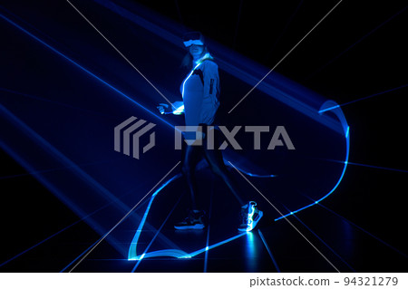 Woman is using virtual reality headset to access in metaverse. Woman is using virtual reality headset to access in metaverse. 94321279
