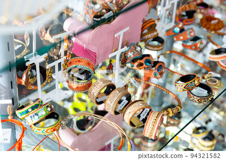 Fashionable handmade bracelets on the showcase of jewelry store 94321582