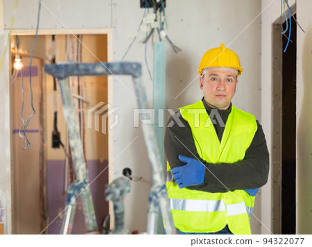 Portrait of construction worker standing at indoors building site Portrait of construction worker standing at indoors building site 94322077