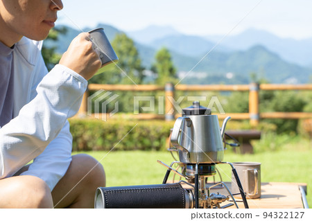 Man drinking coffee outdoors Man drinking coffee outdoors 94322127