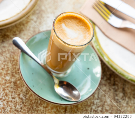 Mug of cortado served on table in cafe 94322293