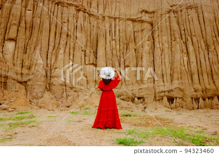 Women and landscape of soil textures eroded sandstone pillars, columns and cliffs, natural erosion of water and wind, Sao Din Na Noi, Hom Chom, Khok Suea at sri nan national park in Nan Province. Women and landscape of soil textures eroded sandstone pillars, columns and cliffs, natural erosion of water and wind, Sao Din Na Noi, Hom Chom, Khok Suea at sri nan national park in Nan Province. 94323460