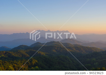 Aerial View of Doi chiang dao mountains in the morning and the sea of mist, Doi Kham Fa. Chiang Mai Province, Thailand. Pink cherry blossom. 94323623