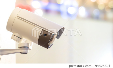 CCTV camera installed on wall of the building. Scan the area for surveillance purposes. CCTV camera installed on wall of the building. Scan the area for surveillance purposes. 94323891