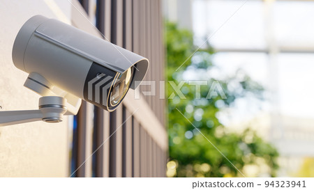 CCTV camera installed on wall of the building. Scan the area for surveillance purposes. 94323941