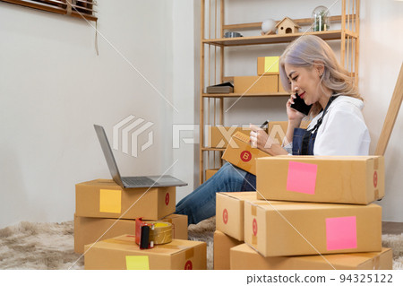 Asian woman entrepreneurs wokring at home with parcel bxes, Small business Startup Ideas. SME or freelance business online and delivery concept. 94325122