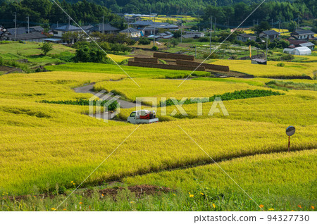 Agricultural vehicles running through Nakano's terraced rice fields 94327730