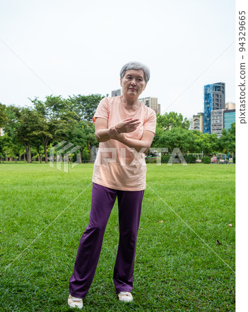 Mature Asian woman in her 60s exercising outdoors feeling uncomfortable with sore wrist. Mature Asian woman in her 60s exercising outdoors feeling uncomfortable with sore wrist. 94329665