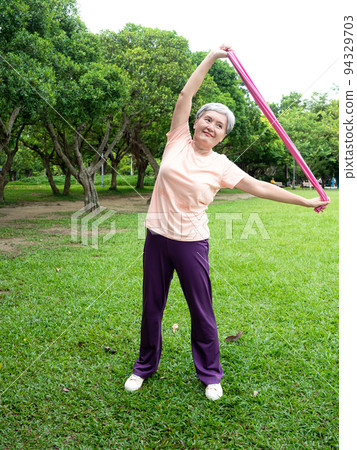Pleasant entertainment at the airport, where women smile and use the power belt exercise on the grass, as well as enjoy the fresh air of nature in the park. Pleasant entertainment at the airport, where women smile and use the power belt exercise on the grass, as well as enjoy the fresh air of nature in the park. 94329703