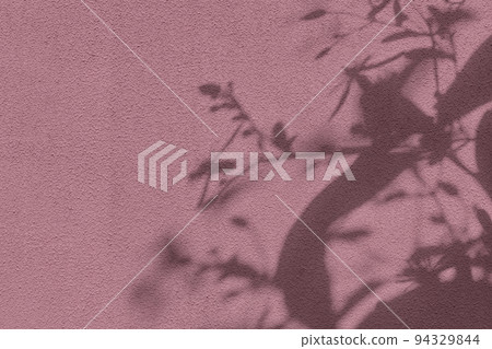 Shadow of leaves on pink concrete wall texture background Shadow of leaves on pink concrete wall texture background 94329844