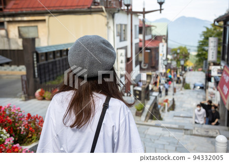 A woman walking along the stone steps of Ikaho Onsen 94332005