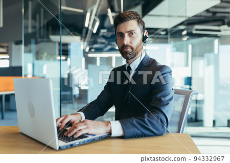 Successful businessman uses headset for online conference, happy man smiling video call Successful businessman uses headset for online conference, happy man smiling video call 94332967