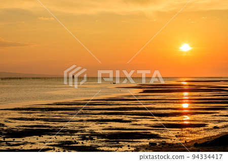Ariake Sea and the sunset at low tide seen from Taiakekaidokoro in summer, Tamana City, Kumamoto Prefecture 94334417