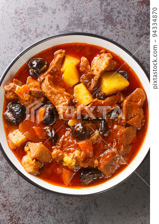 Persian Plum Stew Khoresht Aloo with lamb closeup in the bowl. Vertical top view 94334870