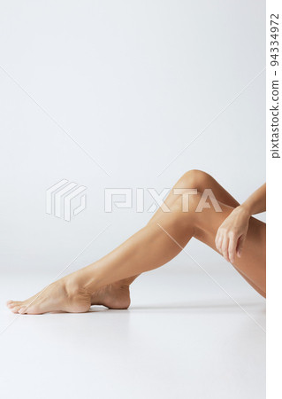 Legs and buttocks. Cropped image of female tanned body of young woman in underwear isolated on gray background. Wellness, weight loss, treatment, health care, fitness 94334972