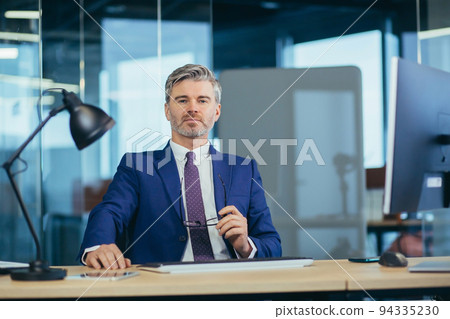 Portrait of successful seo boss, businessman at work, working on computer in modern office, looking at camera, happy and smiling 94335230
