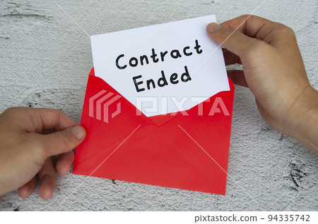 Contract ended text on white notepad with red envelope background. Employment concept 94335742