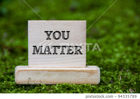 You matter text on wooden block with green nature background. Motivational concept You matter text on wooden block with green nature background. Motivational concept 94335789