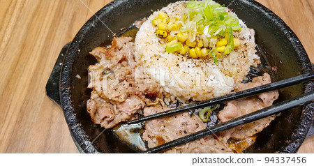selective focus grilled beef steak with korean sauce bulgogi on top of rice with slice of pepper and sweet corn - korean food style 94337456