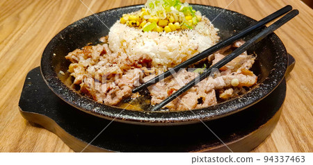 selective focus grilled beef steak with korean sauce bulgogi on top of rice with slice of pepper and sweet corn - korean food style 94337463