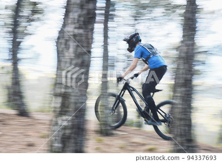 Teenager in forest practicing downhill biking. Teenager in forest practicing downhill biking. 94337693