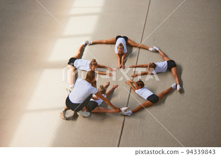 Aerial view. Female sports coach training gymnastics athletes at sports gym, indoors. Concept of sport, studying, art, education 94339843