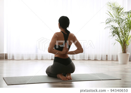 Young woman practicing seiza asana in yoga studio. Vajrasana pose Young woman practicing seiza asana in yoga studio. Vajrasana pose 94340650