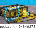 Pirate treasure chest with treasures on the beach. 94340878
