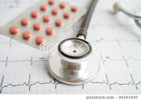 Stethoscope on electrocardiogram (ECG) with drug, heart wave, heart attack, cardiogram report. 94343440