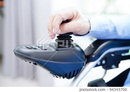 Asian elderly woman disability patient sitting on electric wheelchair in park, medical concept. Asian elderly woman disability patient sitting on electric wheelchair in park, medical concept. 94343700