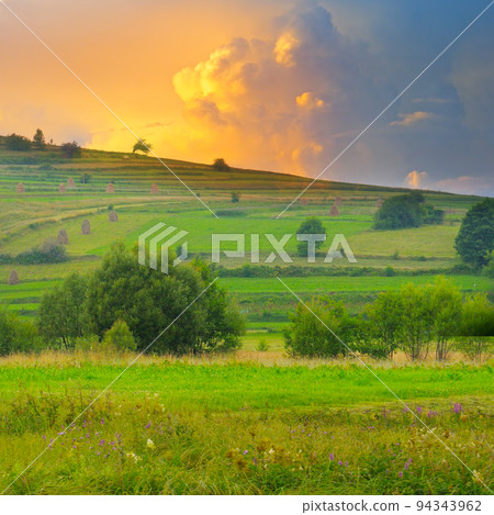 Mountain meadows , haystacks and sunset. Mountain meadows , haystacks and sunset. 94343962