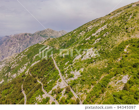 Aerial view on the Old Road serpentine in the national park Lovcen, Montenegro Portrait of a disgruntled girl sitting at a cafe table 94345097