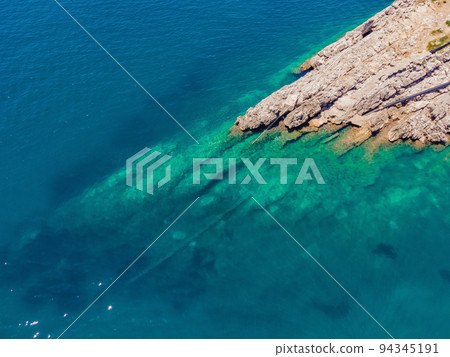 The pipe drains the sewer into the sea. Environmental pollution. Drone view The pipe drains the sewer into the sea. Environmental pollution. Drone view 94345191