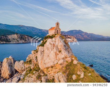 Sveta Nedelja is an islet on the Adriatic Sea, in Montenegrin municipality of Budva. It is located opposite the town of Petrovac na Moru in Montenegro. It has a small church on it Portrait of a Sveta Nedelja is an islet on the Adriatic Sea, in Montenegrin municipality of Budva. It is located opposite the town of Petrovac na Moru in Montenegro. It has a small church on it Portrait of a 94346250