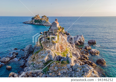 Sveta Nedelja is an islet on the Adriatic Sea, in Montenegrin municipality of Budva. It is located opposite the town of Petrovac na Moru in Montenegro. It has a small church on it Portrait of a 94346252