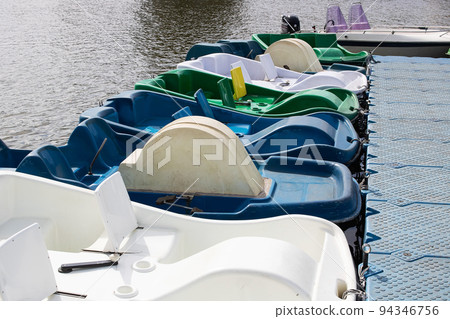 Catamarans parked at the pier on river Catamarans parked at the pier on river 94346756