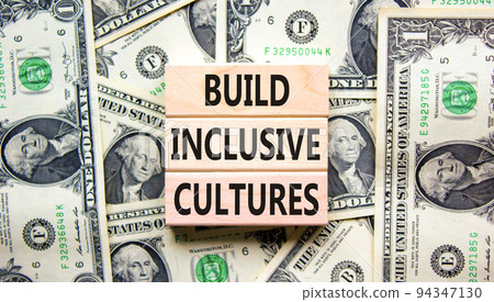 Build inclusive cultures symbol. Concept words Build inclusive cultures on wooden blocks on dollar bills. Beautiful background from dollar bills. Business build inclusive cultures concept. Copy space. Build inclusive cultures symbol. Concept words Build inclusive cultures on wooden blocks on dollar bills. Beautiful background from dollar bills. Business build inclusive cultures concept. Copy space. 94347130