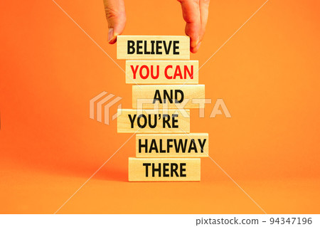 You can symbol. Concept words Believe you can and you are halfway there on wooden blocks on a beautiful orange table orange background. Businessman hand. Business motivational and you can concept. You can symbol. Concept words Believe you can and you are halfway there on wooden blocks on a beautiful orange table orange background. Businessman hand. Business motivational and you can concept. 94347196