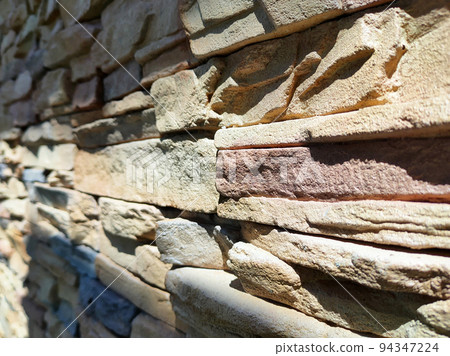 Artificial stone cladding. Designed to resemble real stone. Arranged vertically and attached to the wall with a special adhesive. Used as decoration on the walls of buildings. 94347224