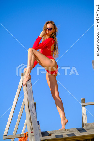 Woman in swimwear against blue sky 94347911