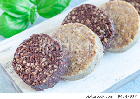 Traditional Irish and British black pudding and white or oatmeal pudding sausage on wooden board Traditional Irish and British black pudding and white or oatmeal pudding sausage on wooden board 94347937