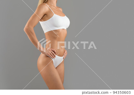 Cropped Image Of Unrecognizable Young Woman With Sporty Body Posing In Underwear Cropped Image Of Unrecognizable Young Woman With Sporty Body Posing In Underwear 94350603
