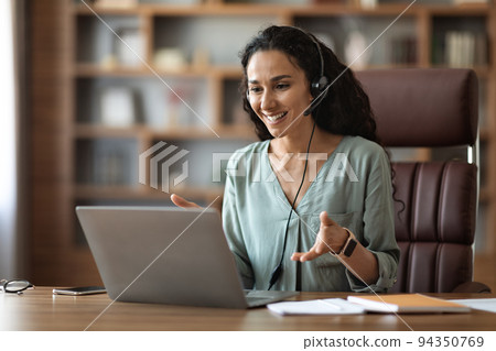 Cheerful middle eastern businesswoman having video conference, copy space Cheerful middle eastern businesswoman having video conference, copy space 94350769