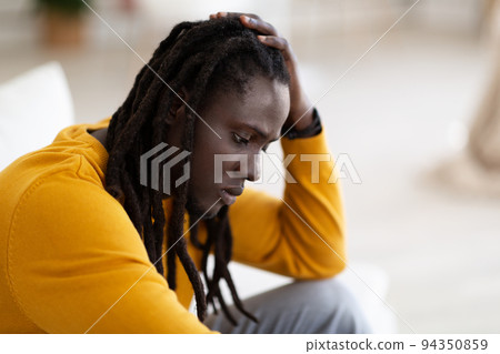 Depression. Portrait Of Upset Black Male With Dreadlocks Sitting At Home Alone Depression. Portrait Of Upset Black Male With Dreadlocks Sitting At Home Alone 94350859