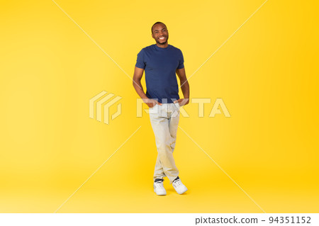 Happy African American Man Posing Standing Over Yellow Background Happy African American Man Posing Standing Over Yellow Background 94351152